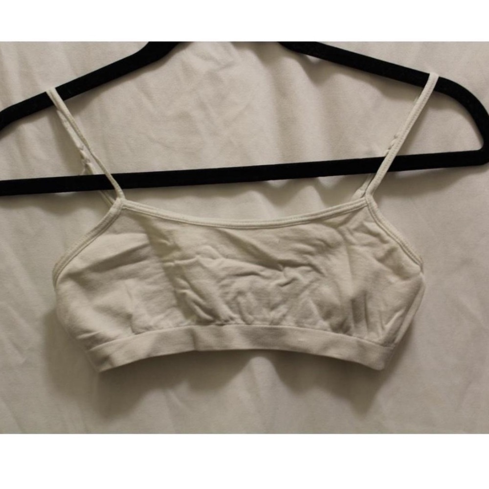 Simple white bralette with adjustable straps.
